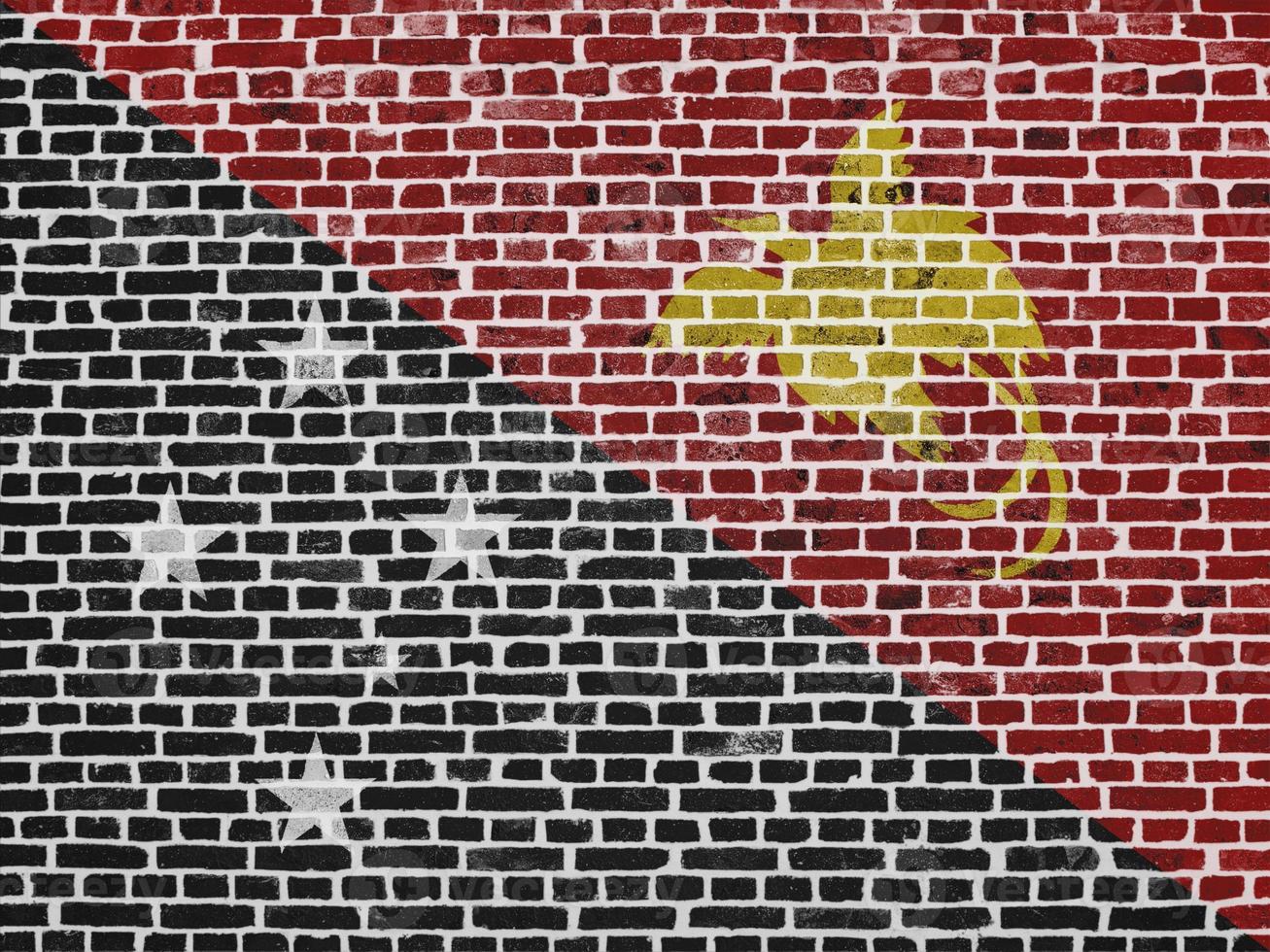 Flag of Papua New Guinea painted on a brick wall photo