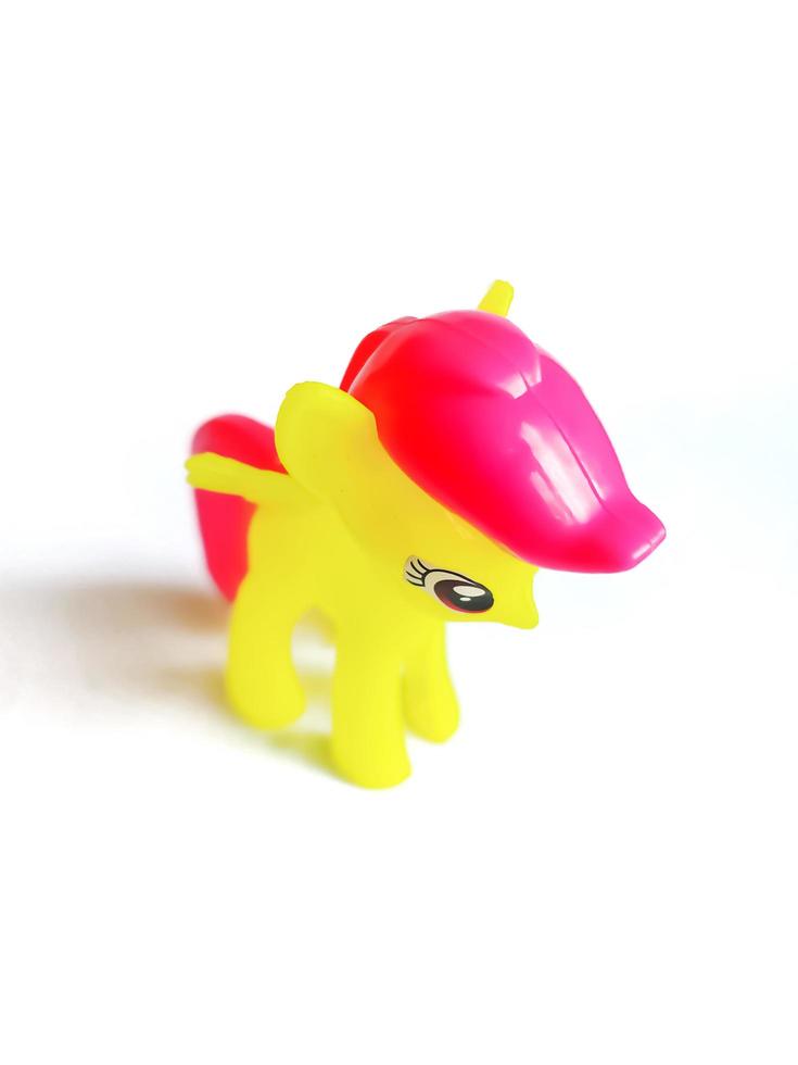 yellow toy horse on white background. photo