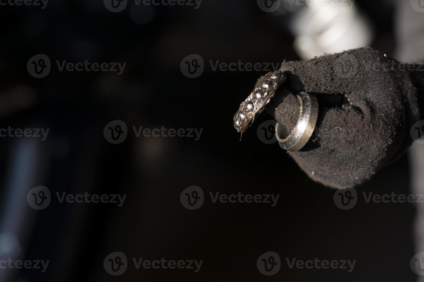 damaged bearing in the hand of a mechanic photo