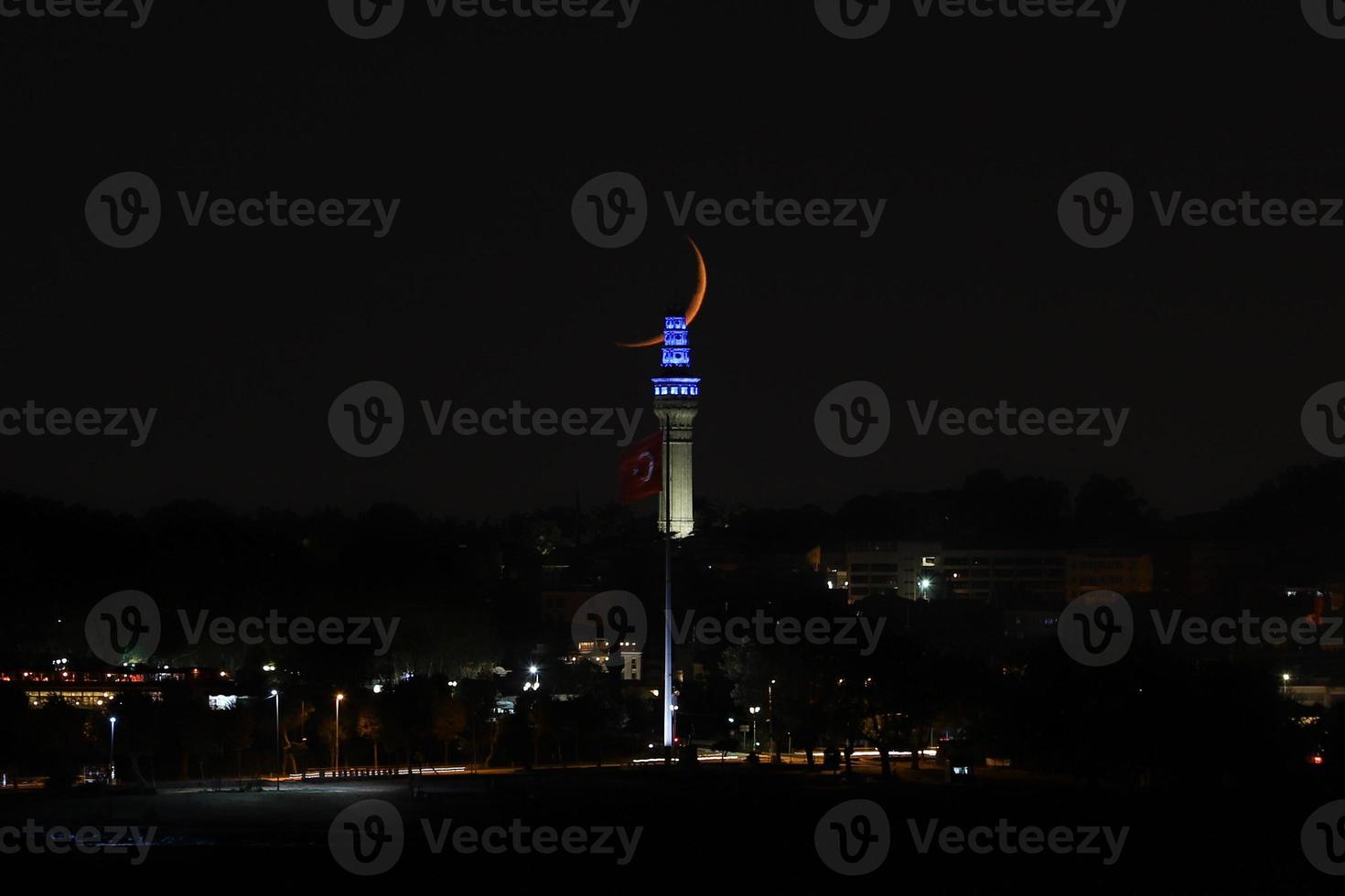 Moonset over Beyazit Tower, Istanbul, Turkey photo