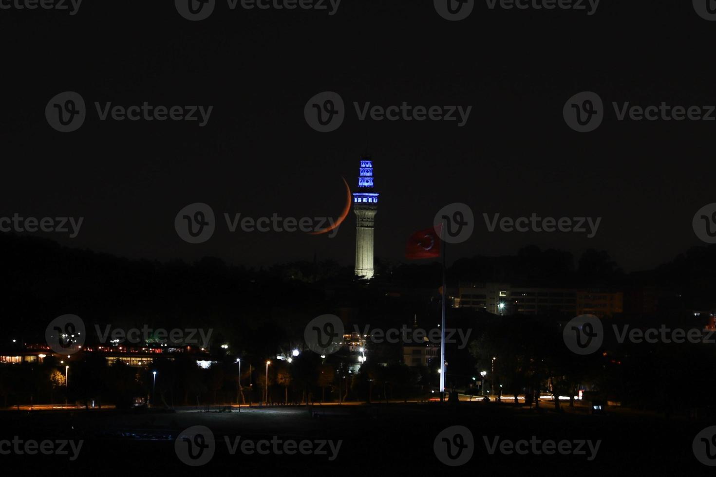 Moonset over Beyazit Tower, Istanbul, Turkey photo