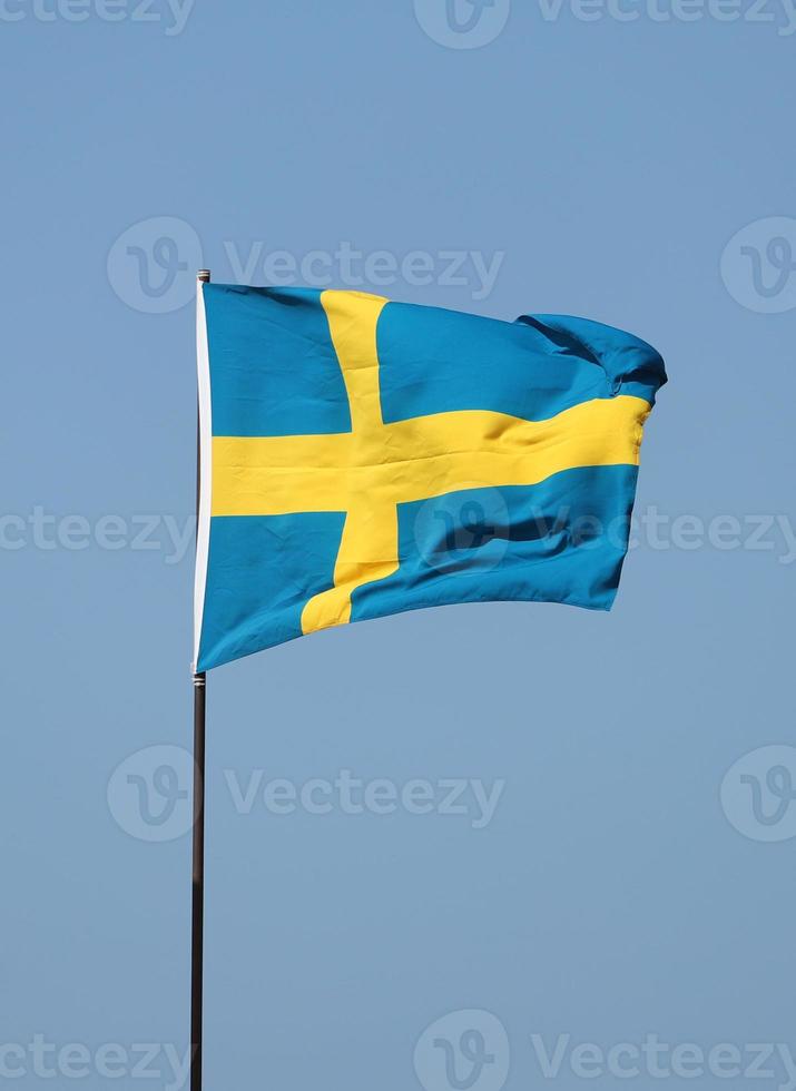 Swedish flag flying on flagpole photo