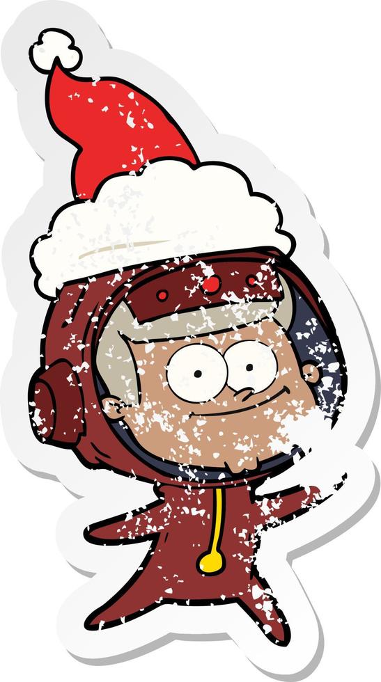 happy astronaut distressed sticker cartoon of a wearing santa hat vector