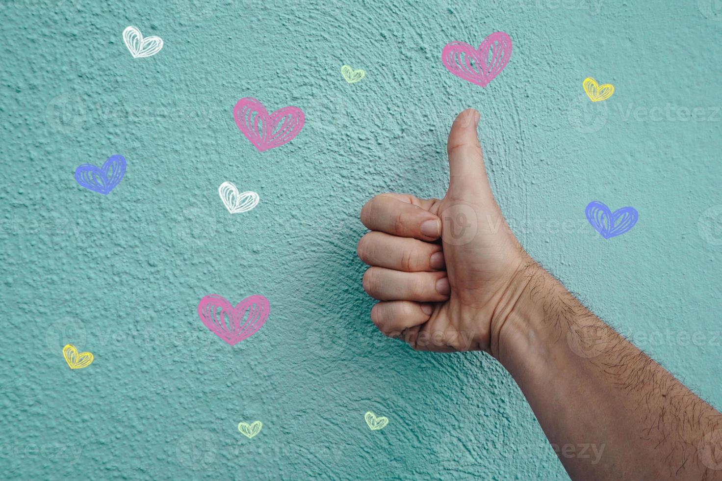 hand on the blue wall with hearts shapes, valentines's day photo