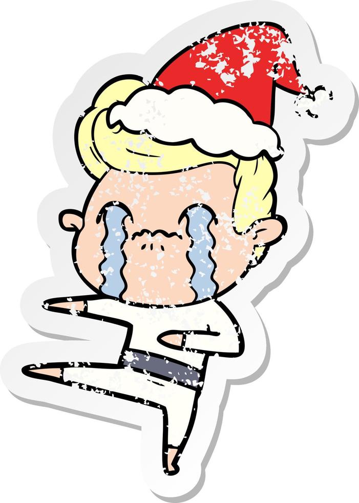 distressed sticker cartoon of a man crying wearing santa hat vector