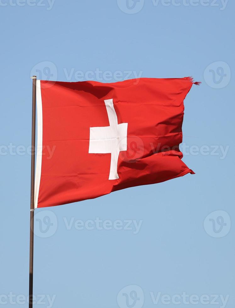 Swiss flag flying on flagpole photo