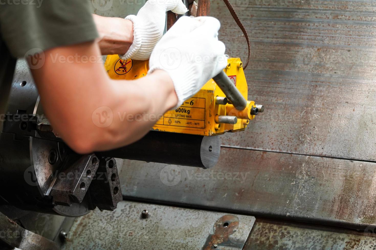 mechanic uses a magnet to lift the workpiece controlled by hand. photo