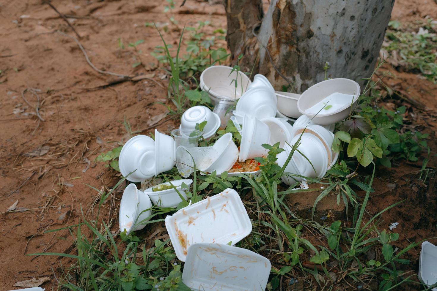 box of waste foam containing used food piled up on the floor in park photo