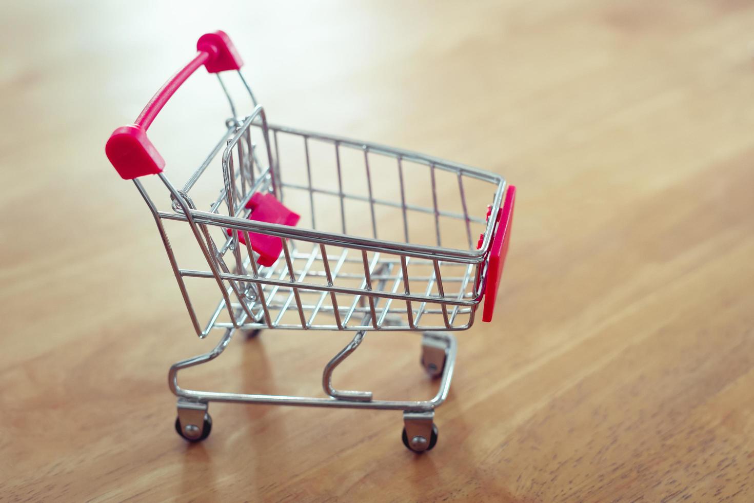 shopping cart on table and sunlight background shopping online concept of modern market photo