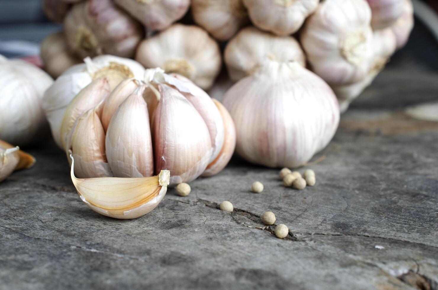 Close up of garlic cloves on wood table backgrounds for raw food photo