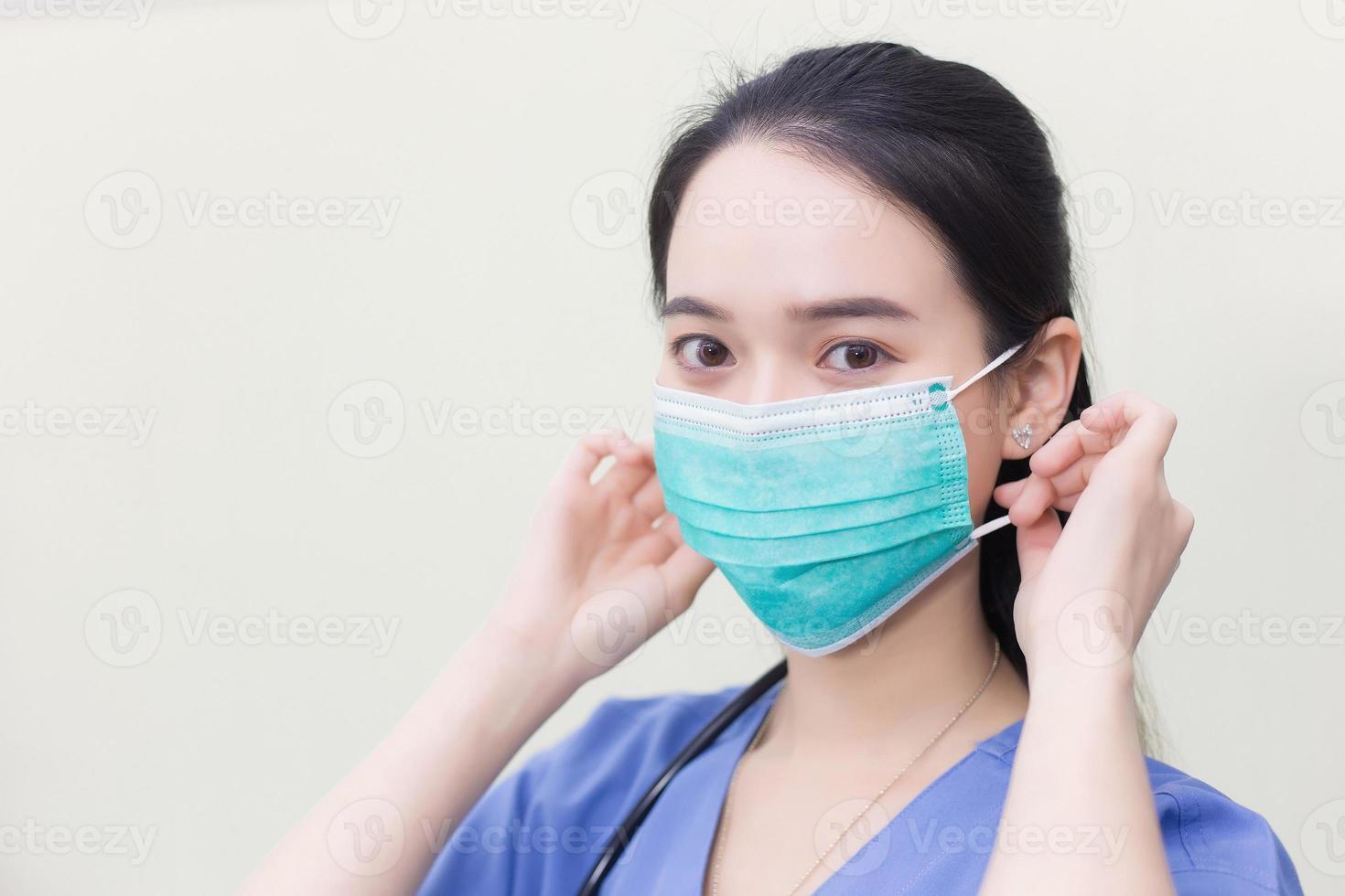 Asian female doctor is wearing medical  face masks to protect from Coronavirus-19 COVID-19 in healthcare and new normal concept. photo