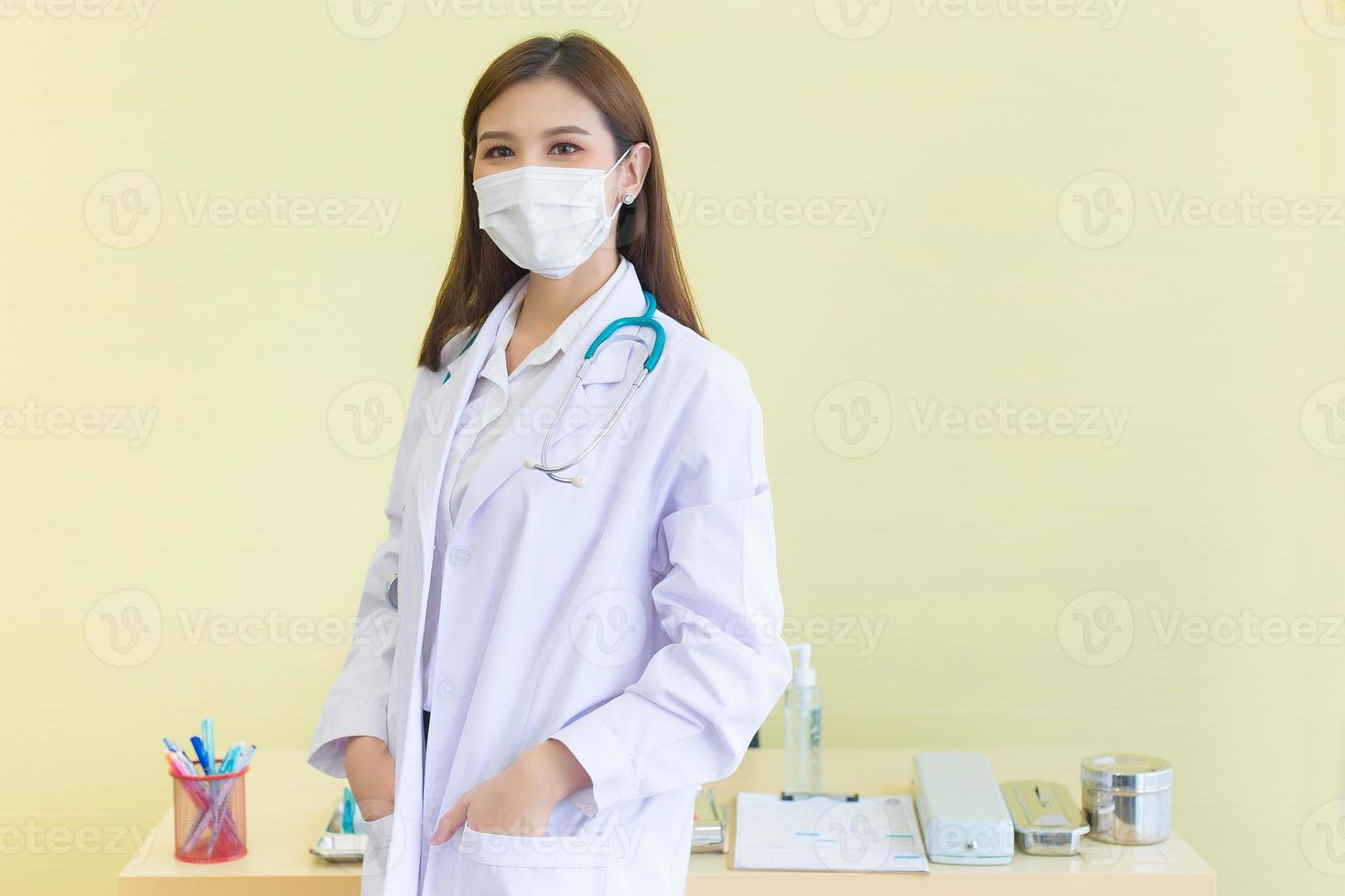 Professional Asian woman doctor wears medical coat and face mask  in health care,pollution PM2.5 and coronavirus protection concept photo