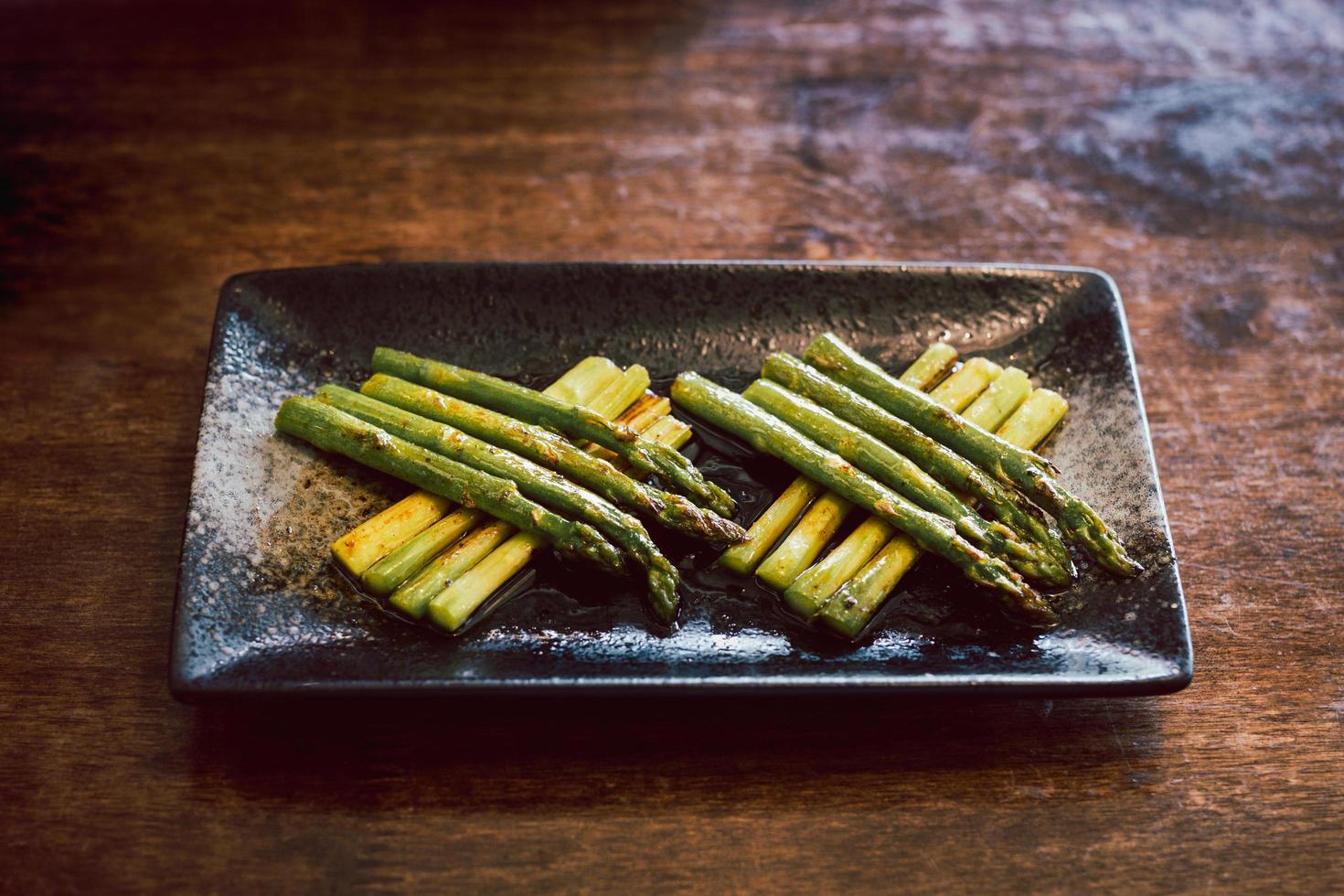Delicious of green asparagus cooked in butter on a plate. photo