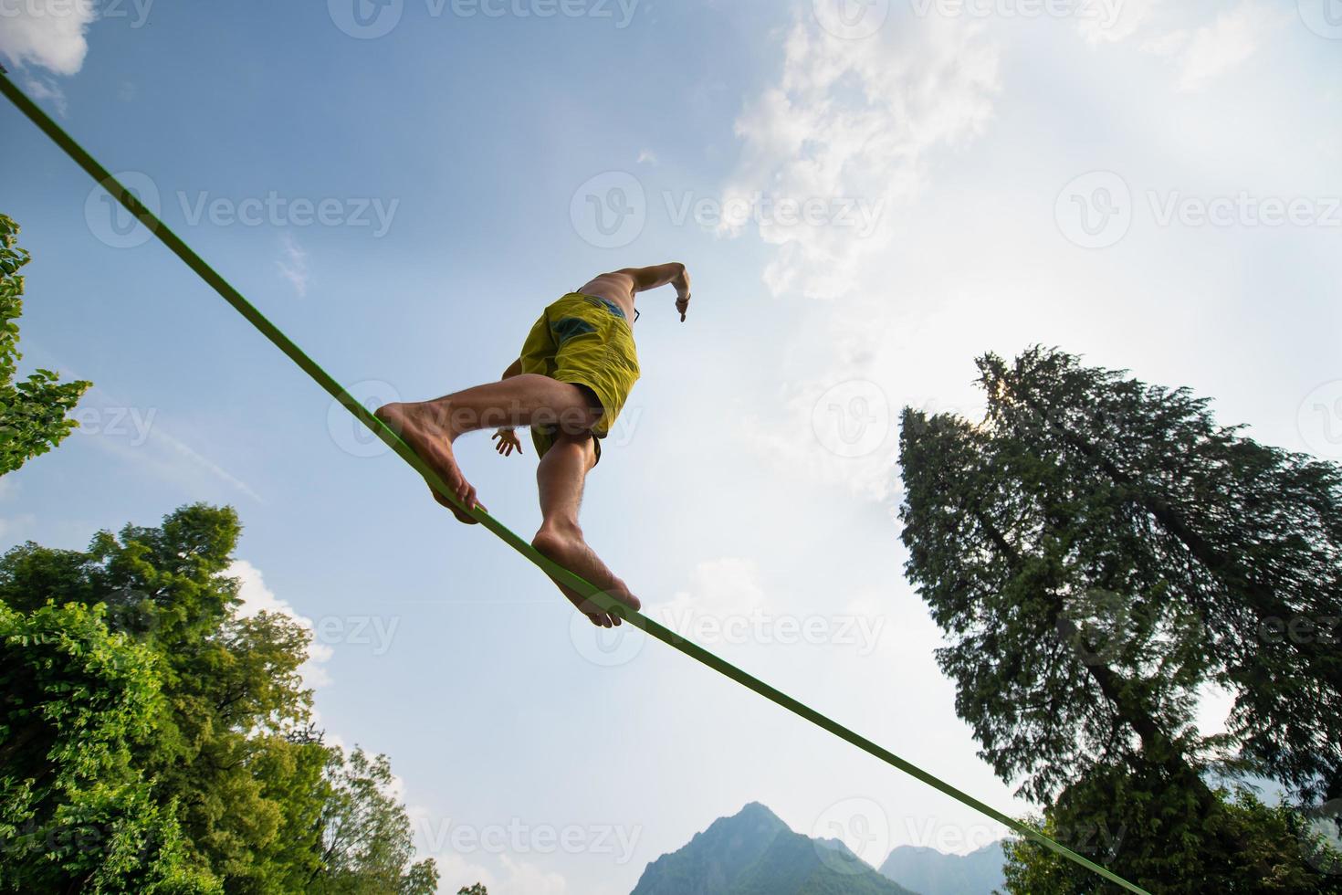 Sporty boy practices walking on the rope photo