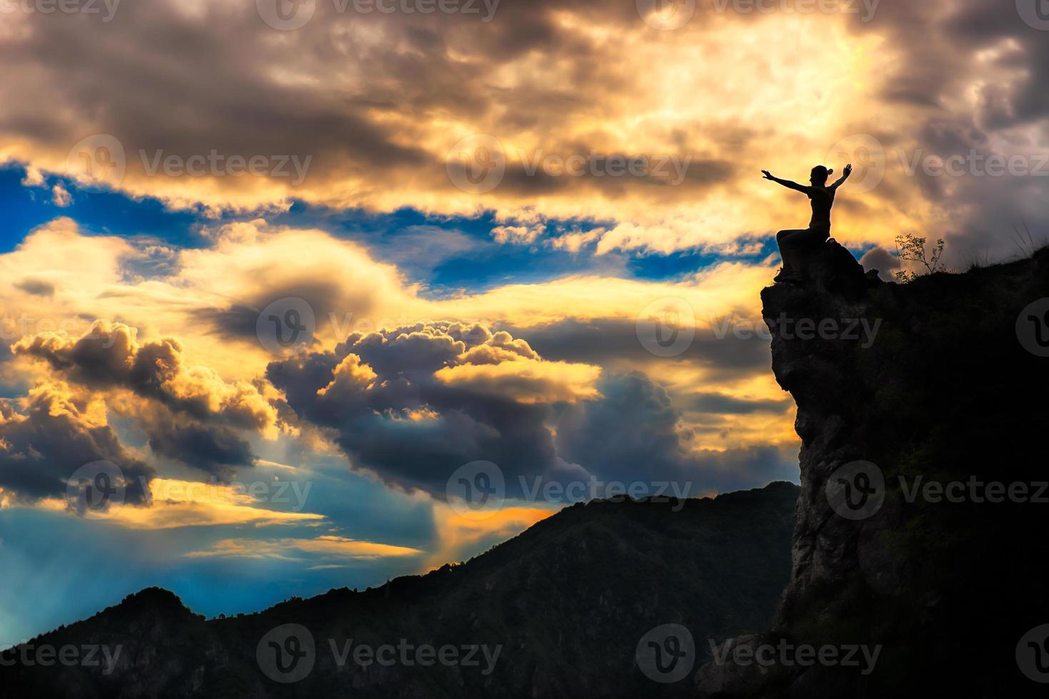 girl on a rock in the mountains photo