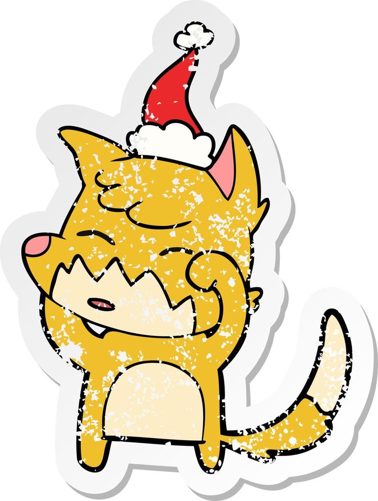 distressed sticker cartoon of a fox wearing santa hat vector