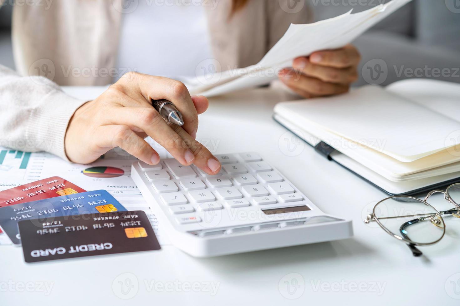 Stressed young woman calculating monthly home expenses, taxes, bank account balance and credit card bills payment, Income is not enough for expenses photo