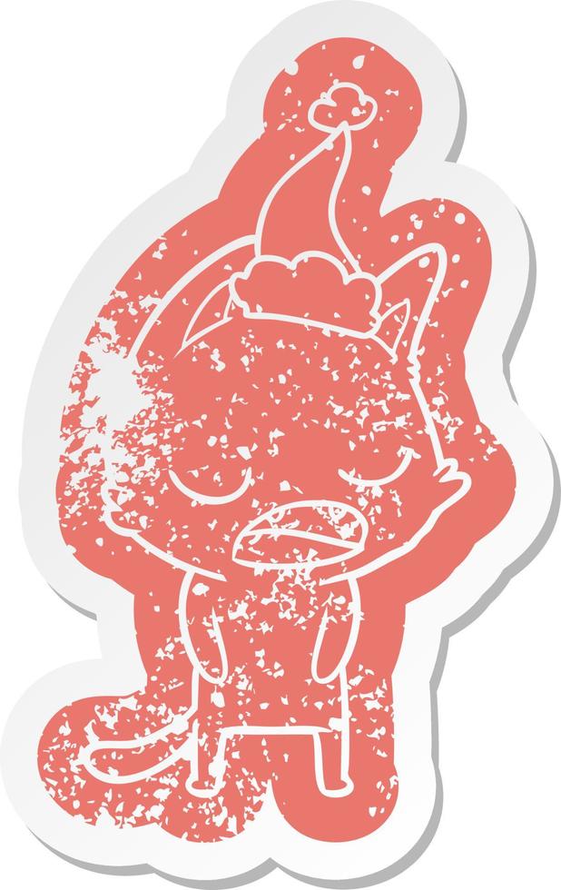 talking cat cartoon distressed sticker of a wearing santa hat vector