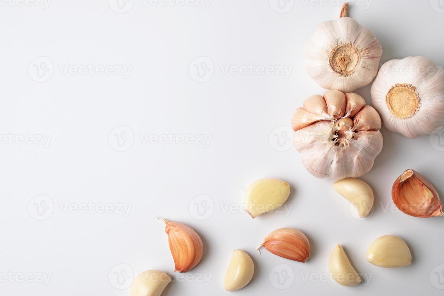 Modern art of garlic with segments isolated on white background photo