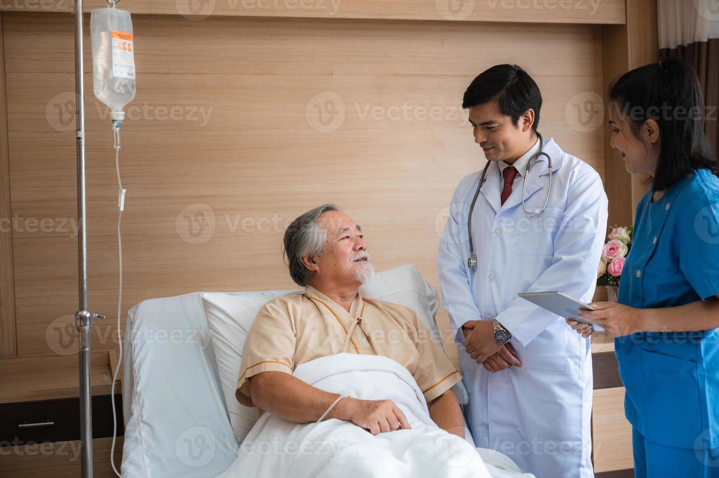 senior elderly patient person visit doctor for health care checkup at hospital, health insurance medical care concept, old man having disease and making medicine help support by nurse at clinic photo