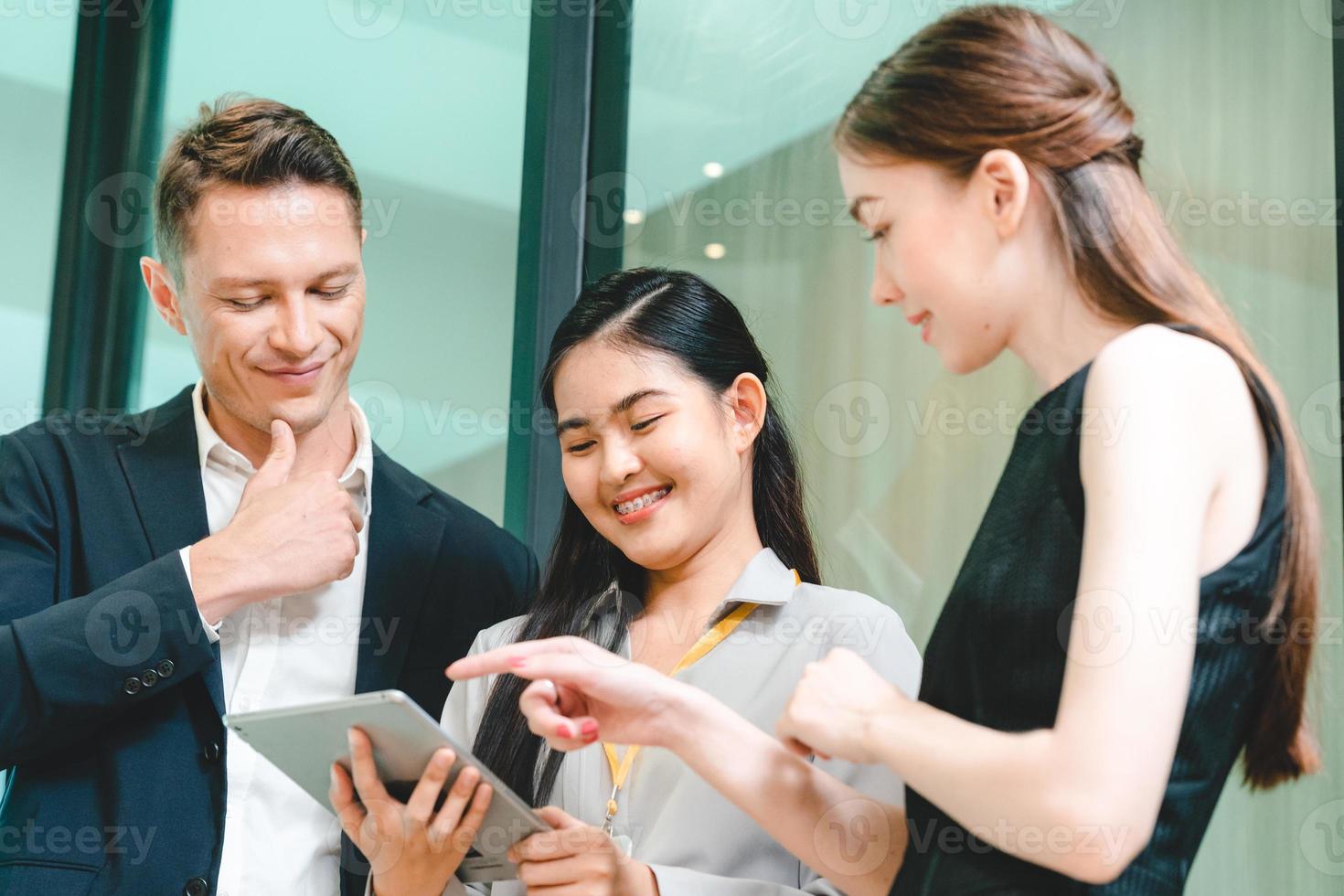 Team of young male and female employees stacking hands on top of each others to depict unity and harmony amongst colleagues for project and positive work environment photo