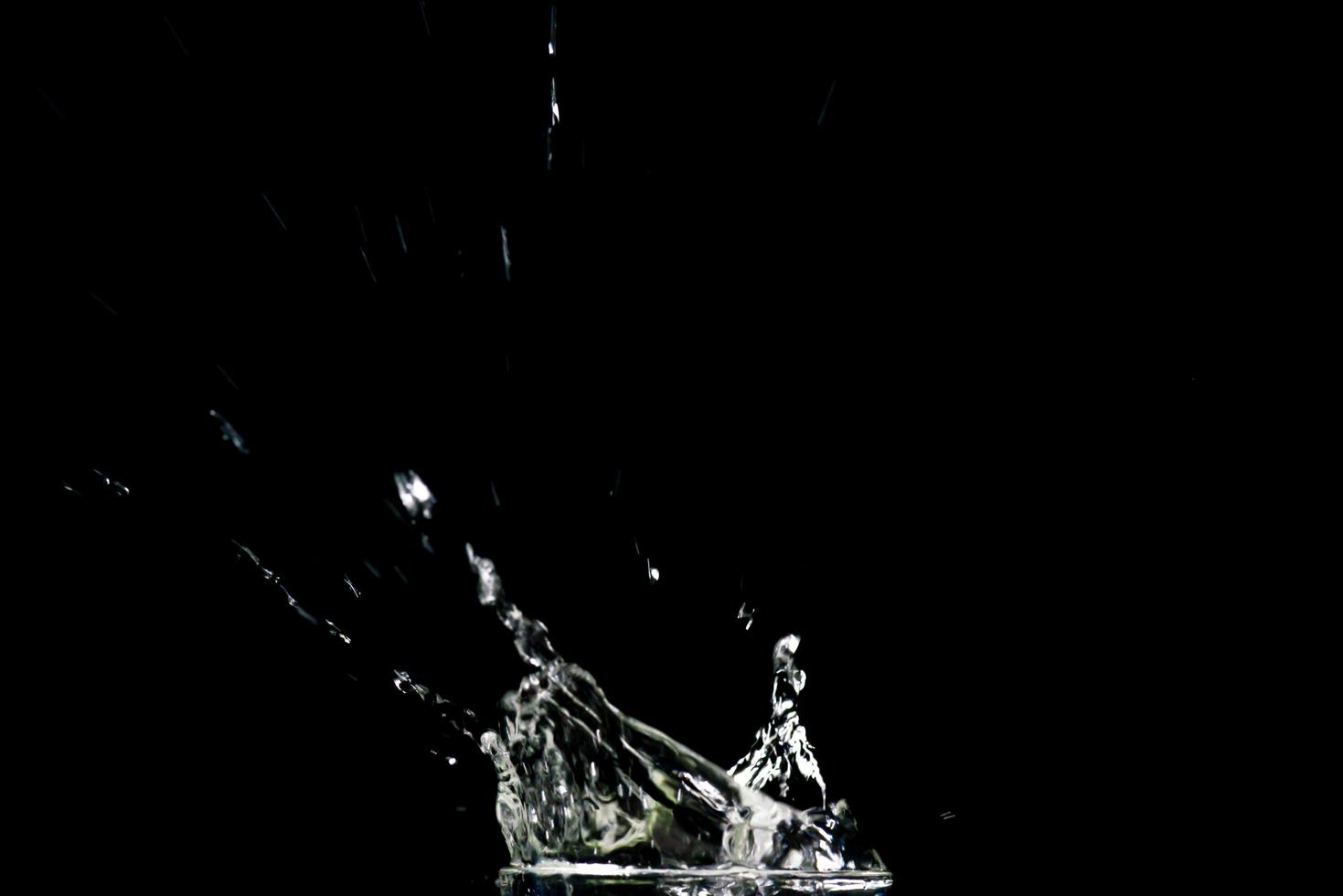 Water splashing on a black background. abstract background of water diffused on black background photo