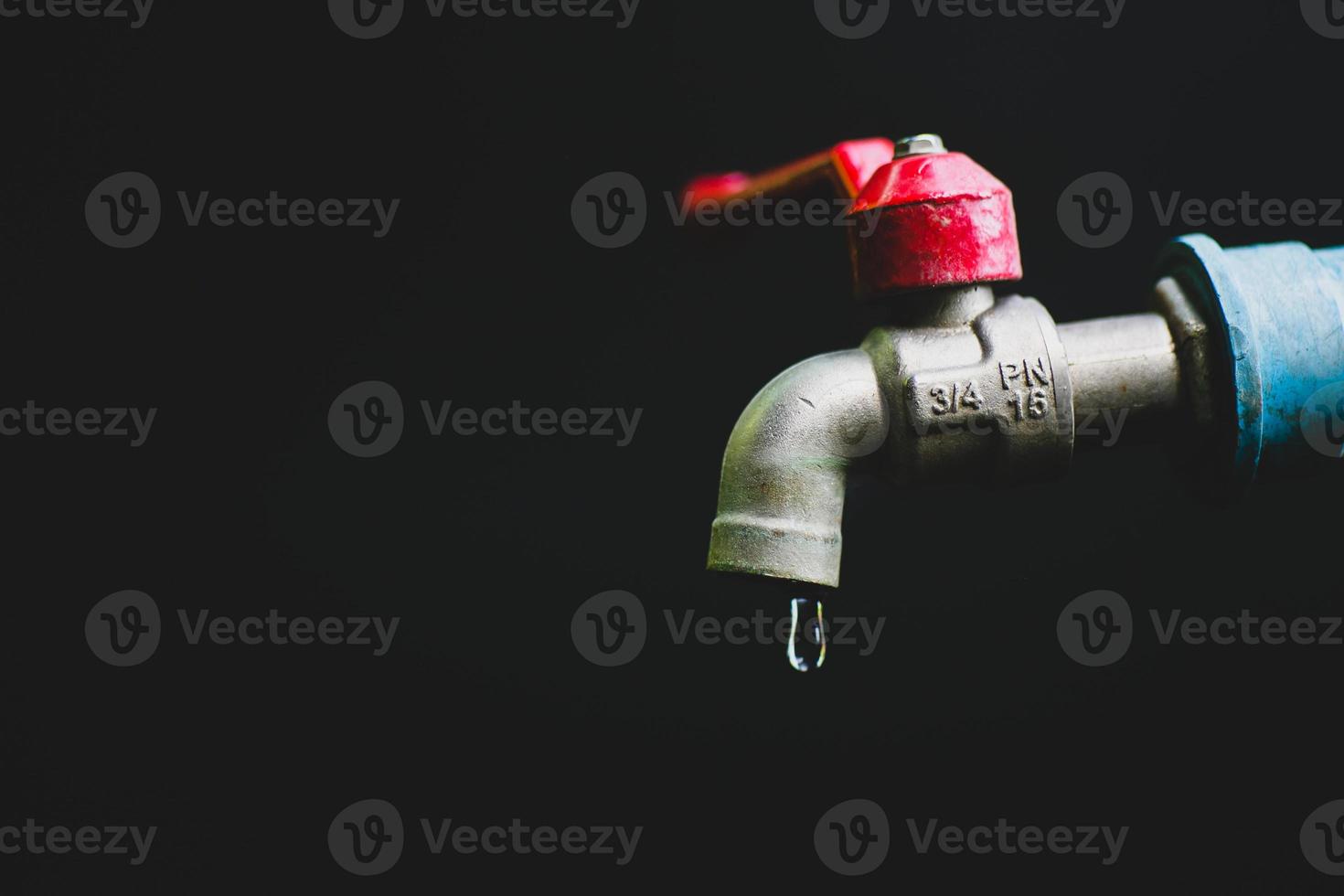 Crisis concept of fresh water shortage due to environmental changes. water tap without running water On a black background there is a copy space. photo