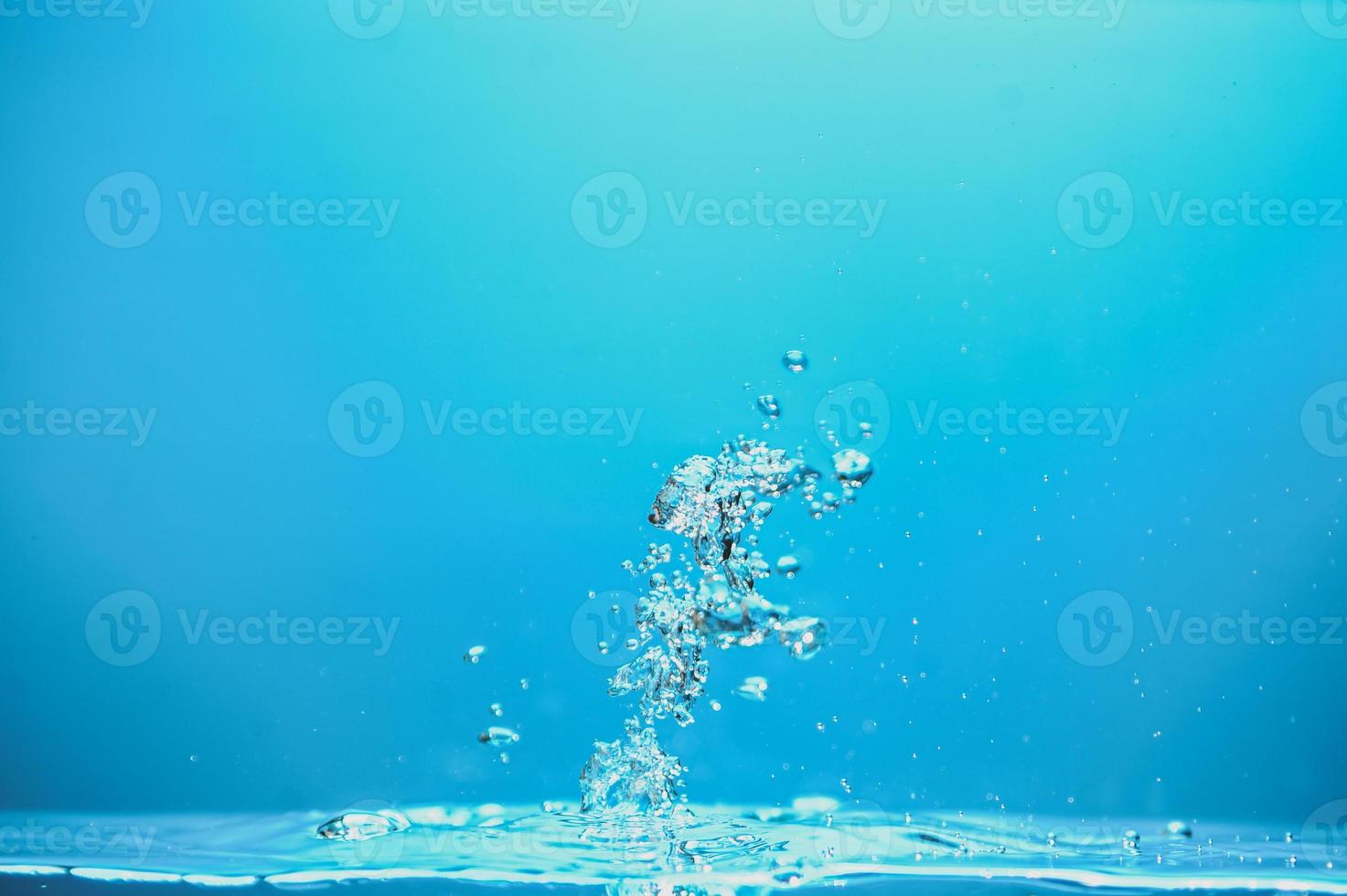 Abstract background image of bubbles in water. Clean water with water droplets and waves. Fresh water a glass with bubbles blue background. photo