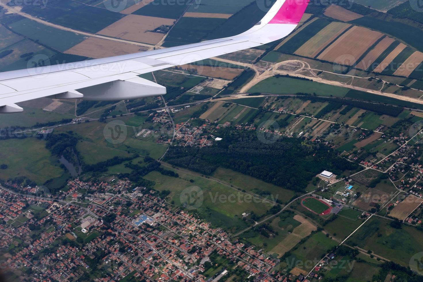 The earth is visible through the window of an airplane photo