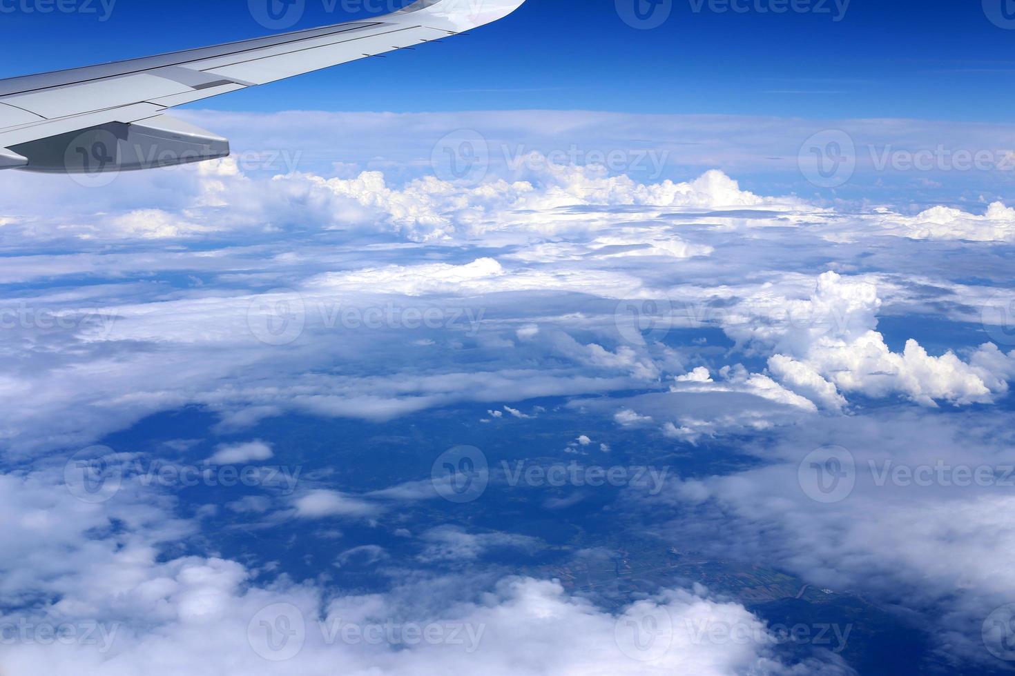 The earth is visible through the window of an airplane photo