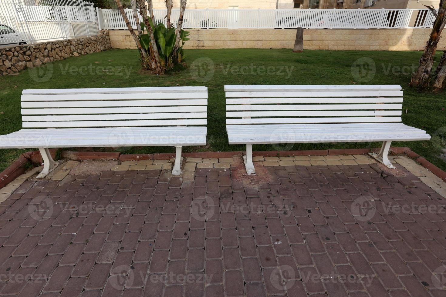 Bench for rest in a city park on the Mediterranean coast in northern Israel photo