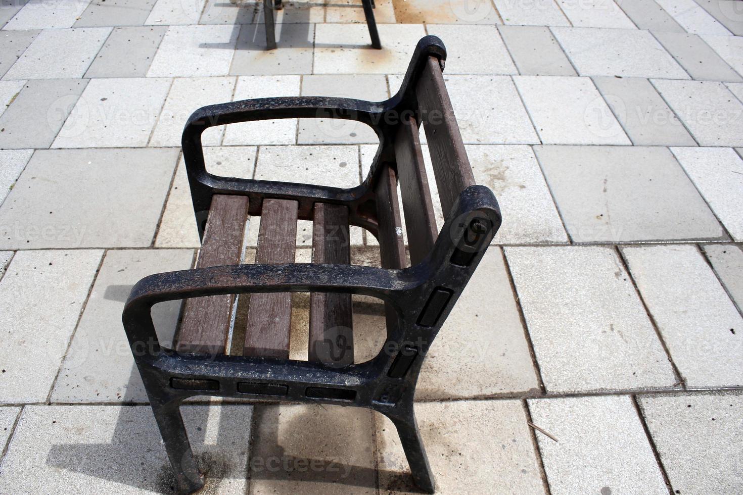Bench for rest in a city park on the Mediterranean coast in northern Israel photo