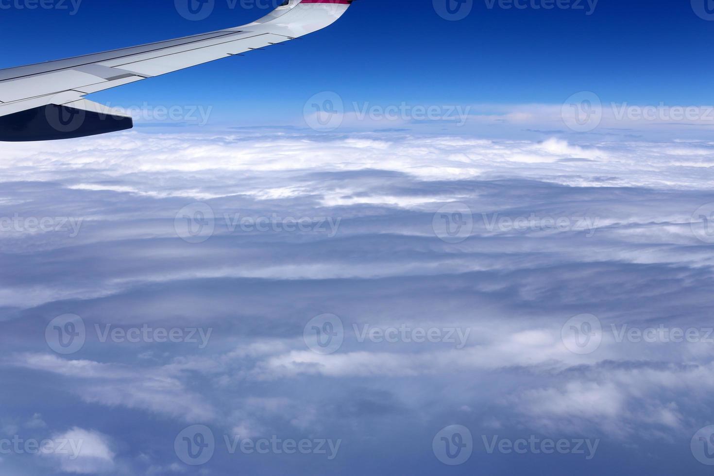 The earth is visible through the window of an airplane photo