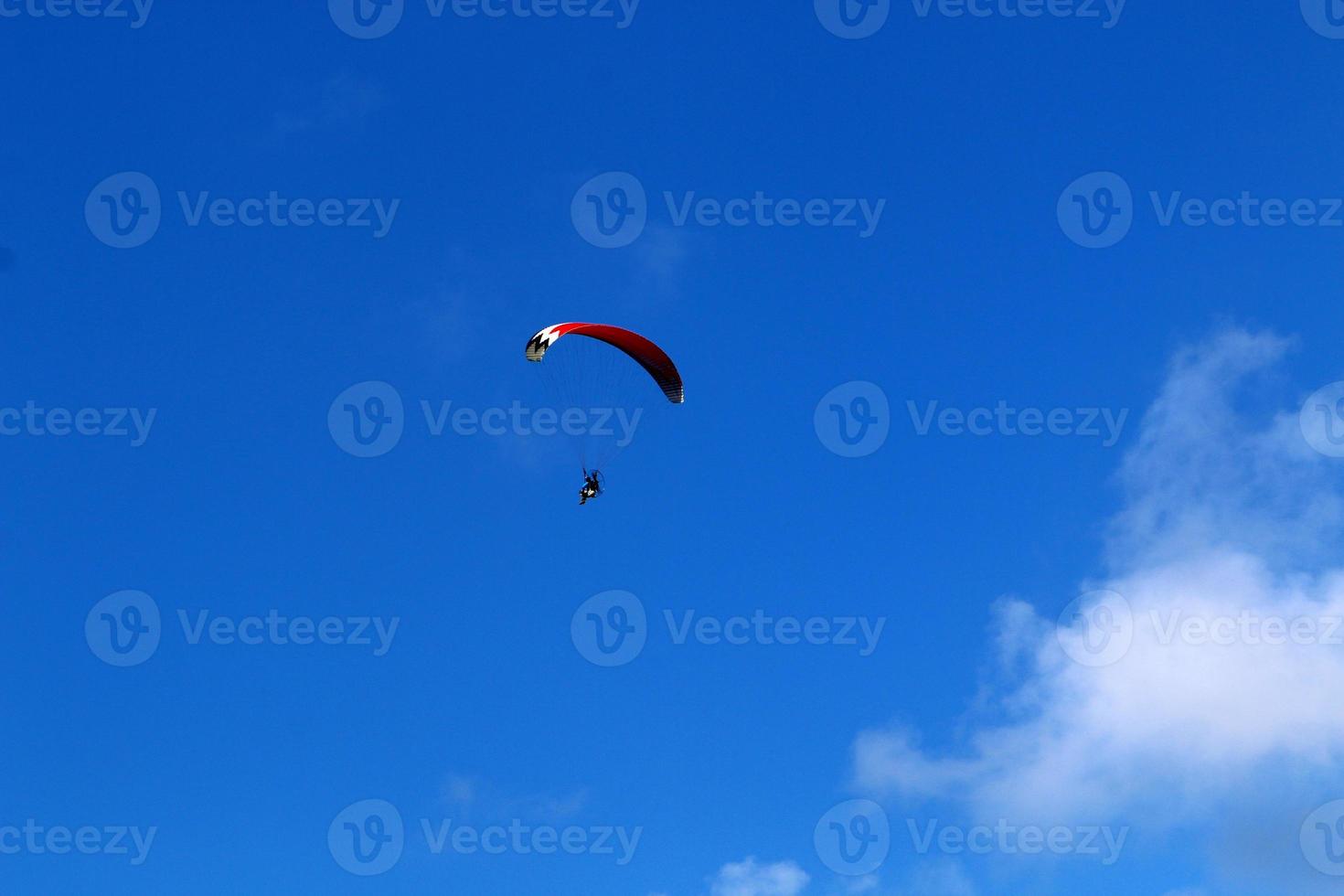 A paraglider flies over the Mediterranean Sea in northern Israel photo