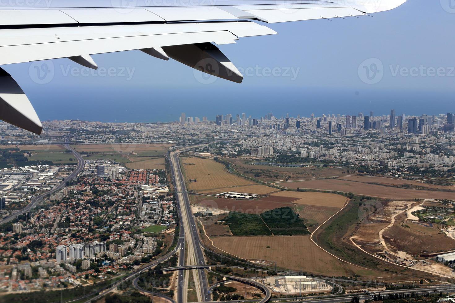 The earth is visible through the window of an airplane photo
