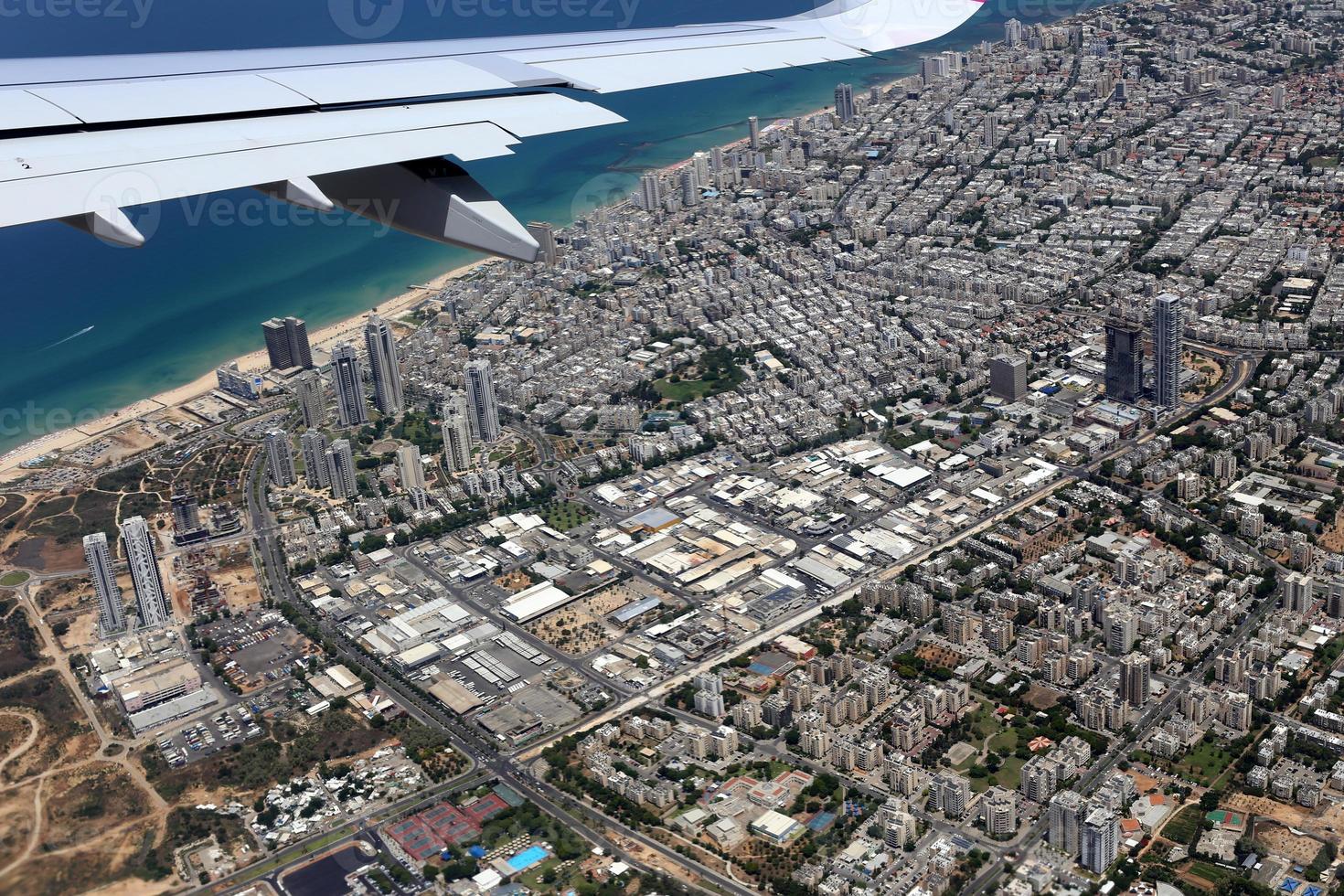 The earth is visible through the window of an airplane photo
