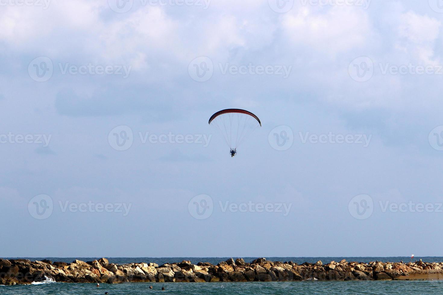 A paraglider flies over the Mediterranean Sea in northern Israel photo