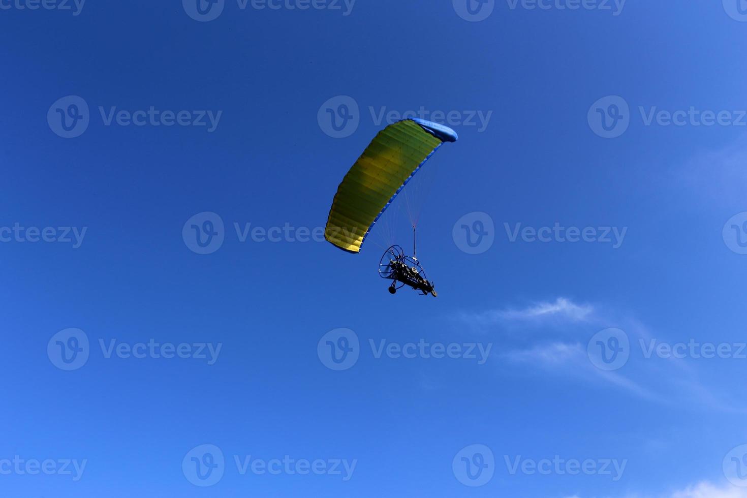 A paraglider flies over the Mediterranean Sea in northern Israel photo