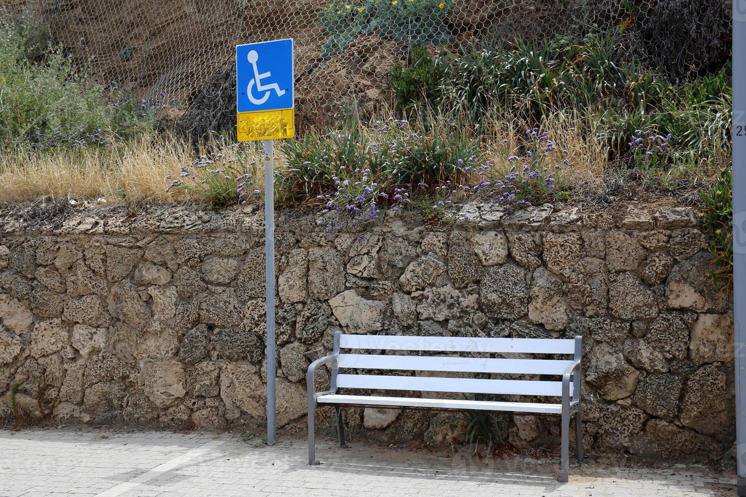 Bench for rest in a city park on the Mediterranean coast in northern Israel photo