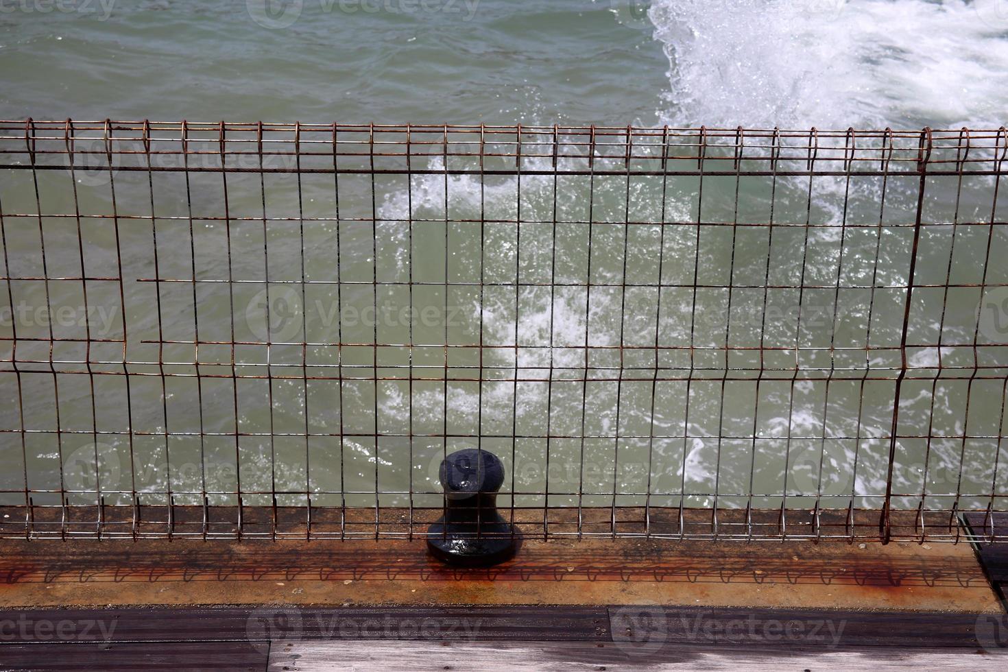 Fence in a city park on the Mediterranean Sea in Israel photo