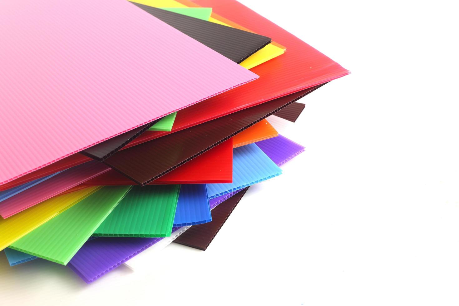 Group of colorful corrugated plastic sheets on white photo
