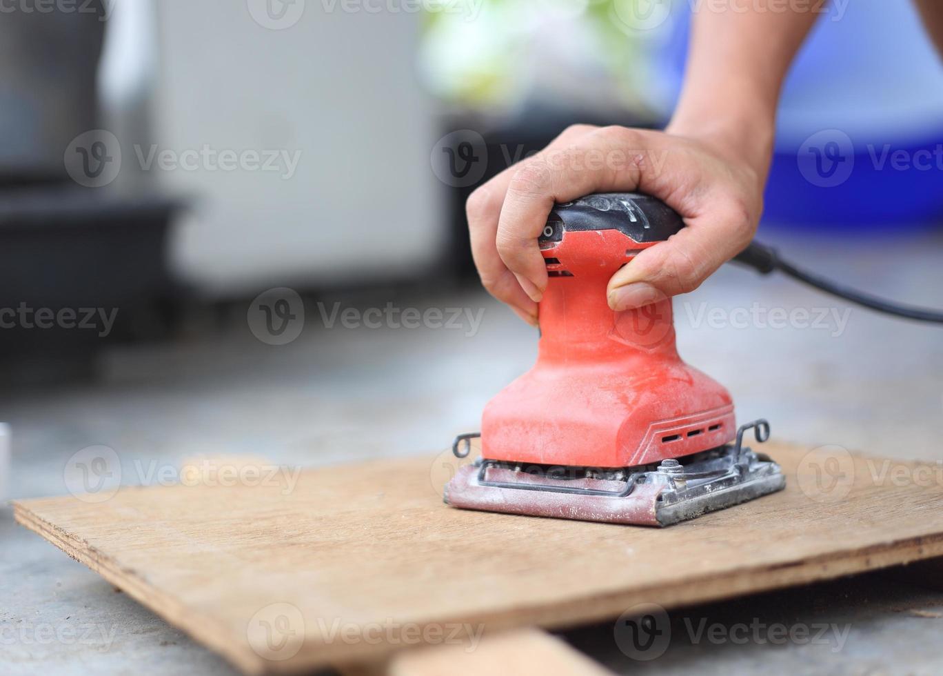 Hand hold machine sanding polishing wood photo