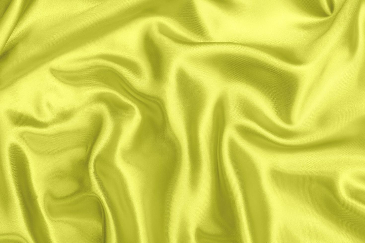 Yellow satin fabric texture soft blur background photo