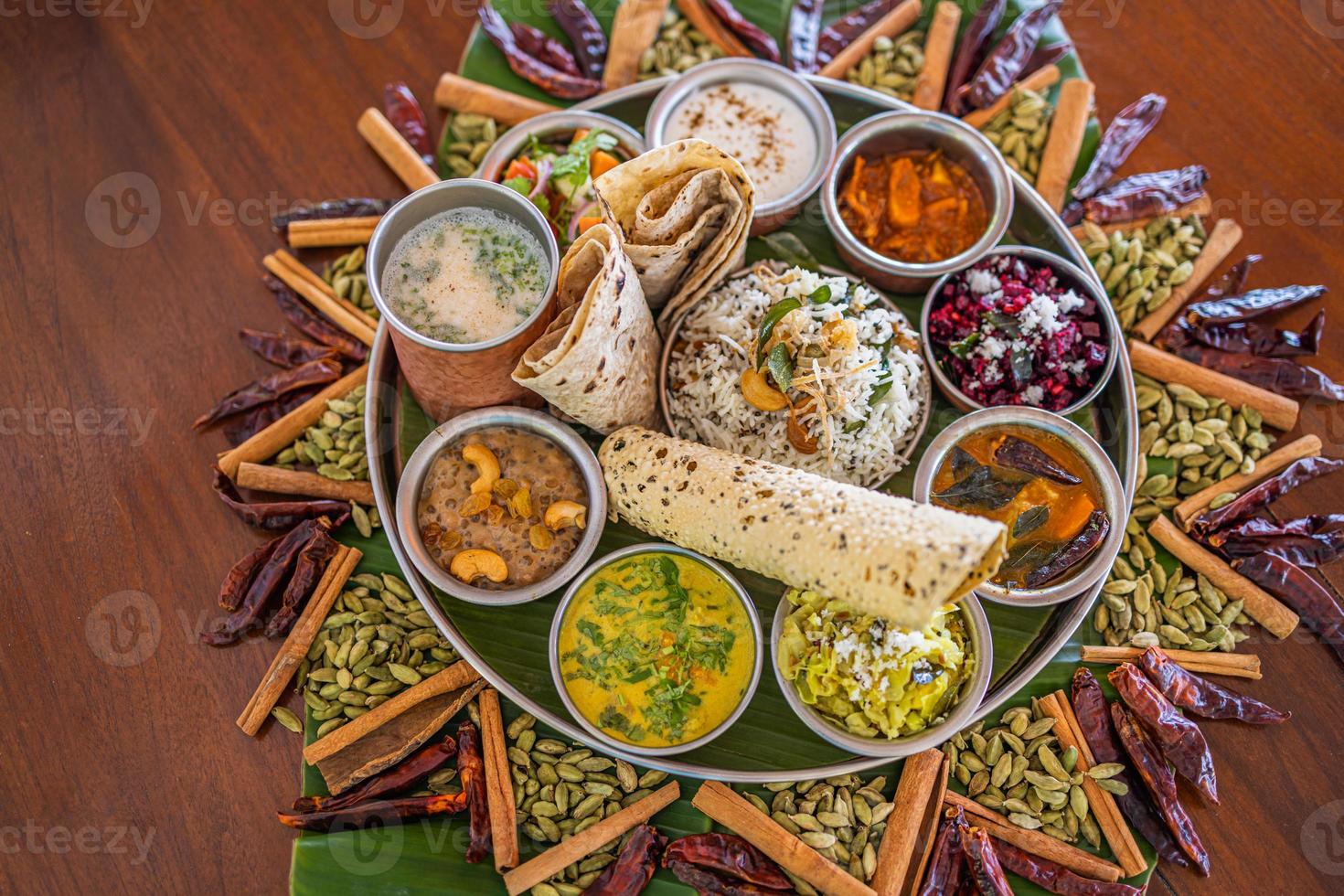 Indian food Curry butter chicken, Palak Paneer, Chiken Tikka, Biryani, Vegetable Curry, Papad, Dal, Palak Sabji, Jira Alu, Rice with Saffron on dark background photo