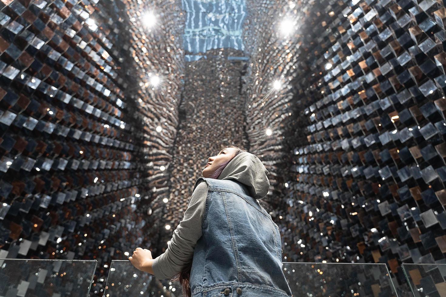 young asia woman acting happy and Look at the beautiful mirrored wall. photo