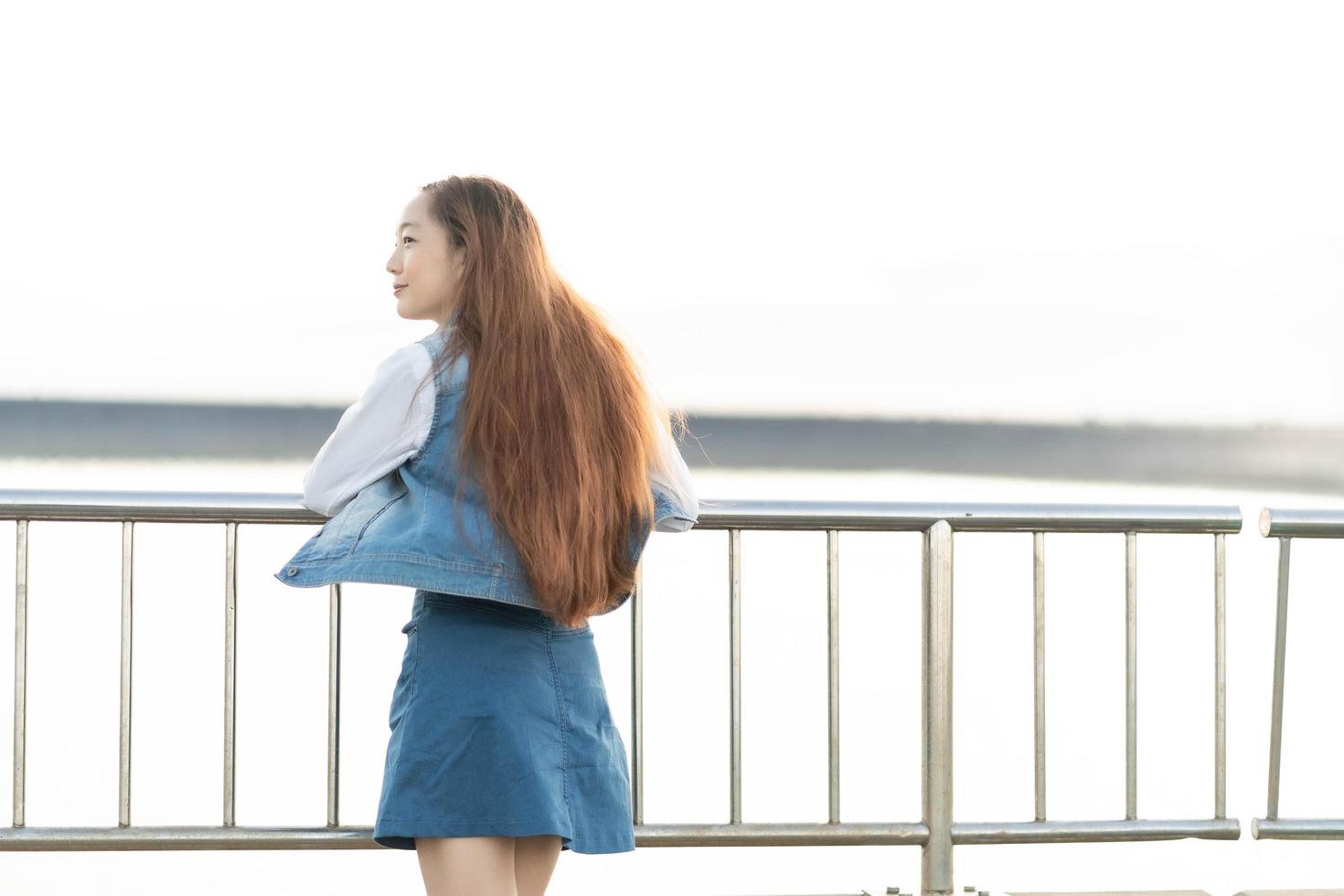 beautiful woman enjoying sunset on bridge. Tourist traveler on background view mockup. photo