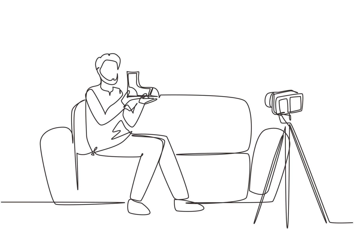 Single continuous line drawing social media influencer reviewing boots. Smiling young Arab man vlogging about men's sports shoe and filming himself at home on video camera. One line draw design vector