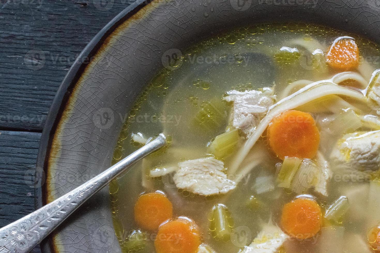 homemade chicken soup with vegetables flat lay photo