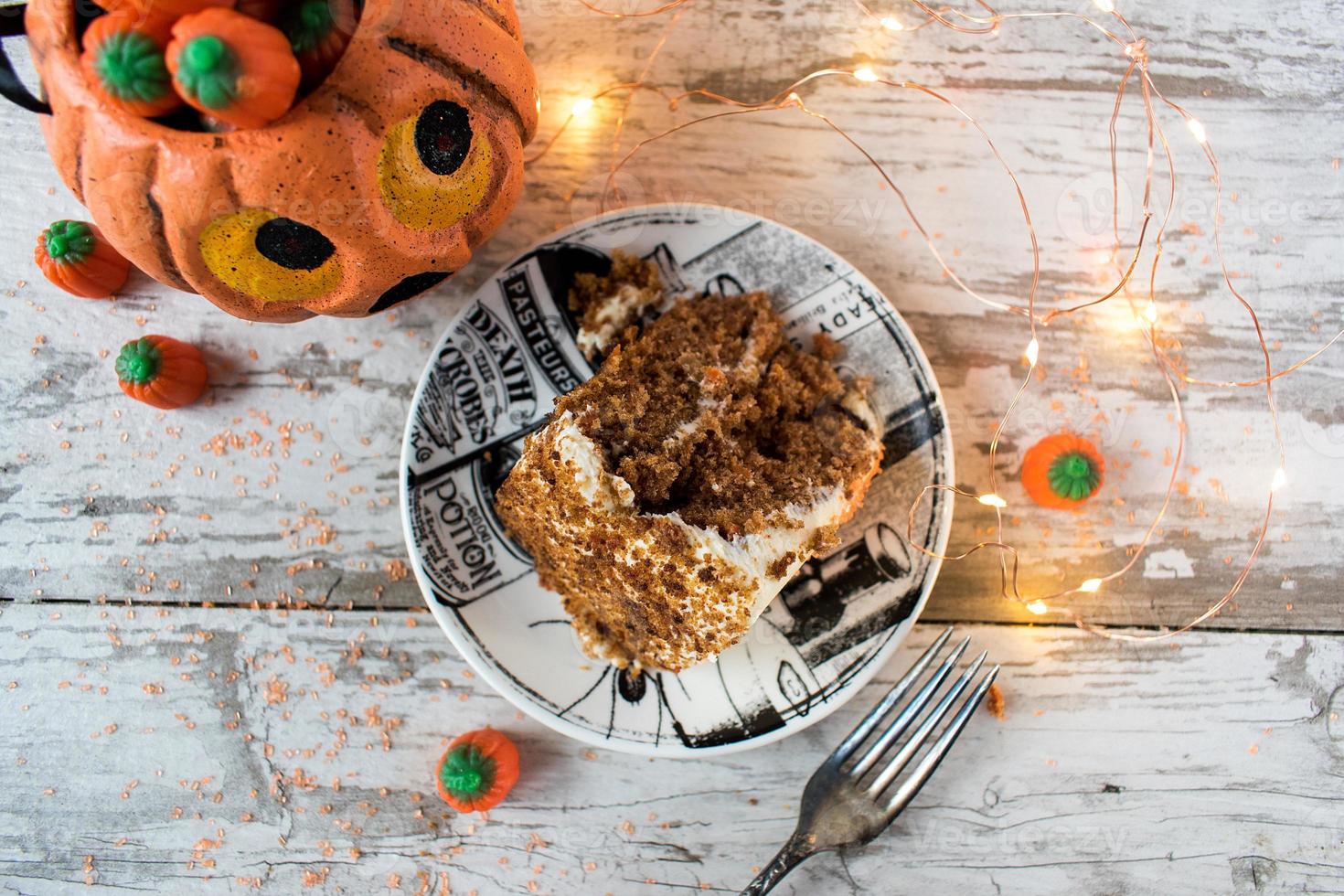 Halloween spice cake slice with lights and decorations flat lay photo