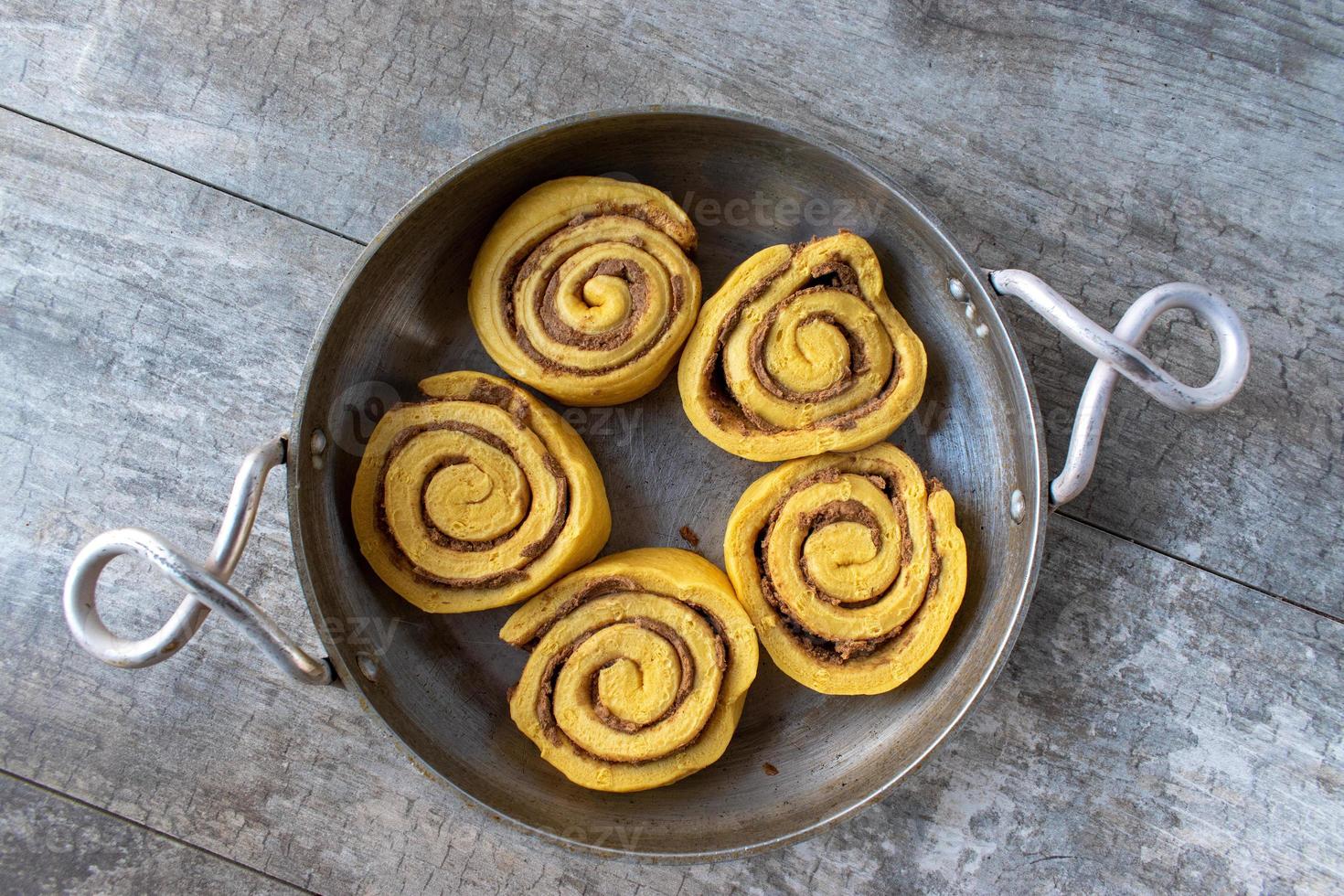 preparing pumpkin cinnamon rolls for baking flat lay photo